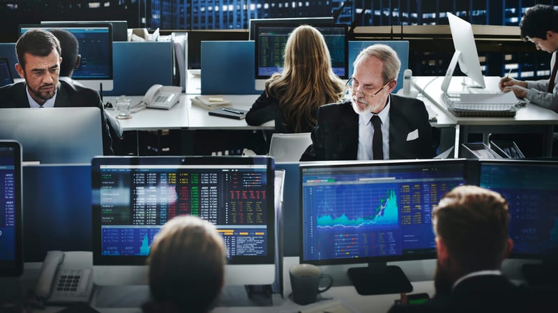People using technology in financial risk management