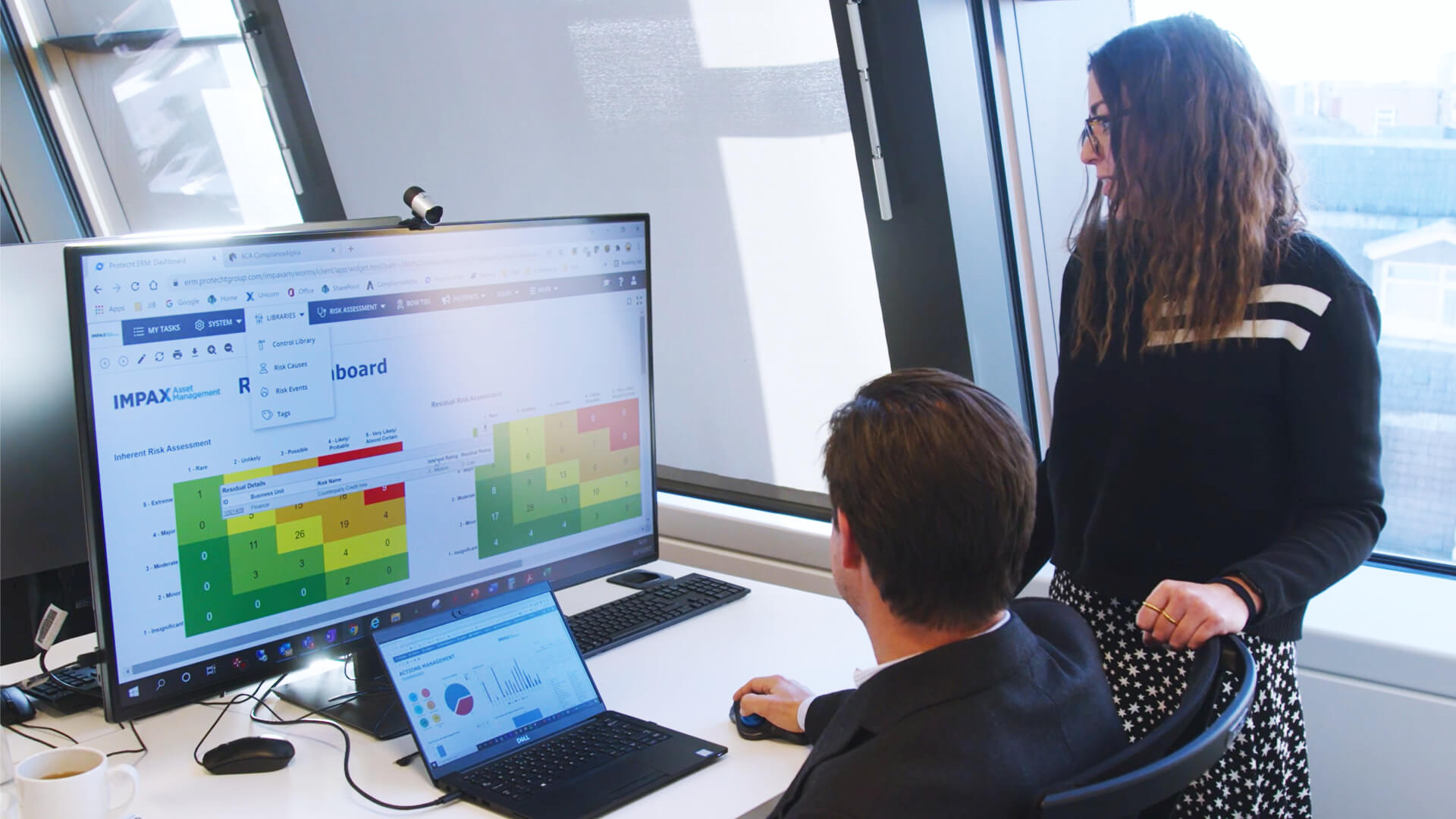Staff at Impax Asset Management looking at a Risk Assessment dashboard in Protecht.ERM