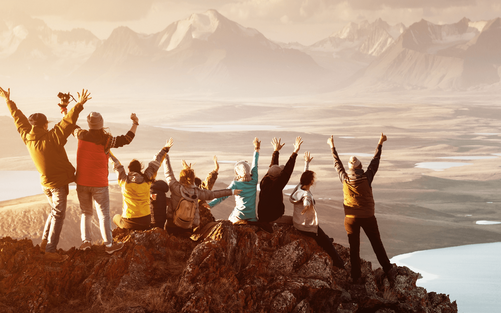 Team of hikers celebrating at the top of a mountain; featured image for Protecht's announcement of $42m raised in Series A Funding